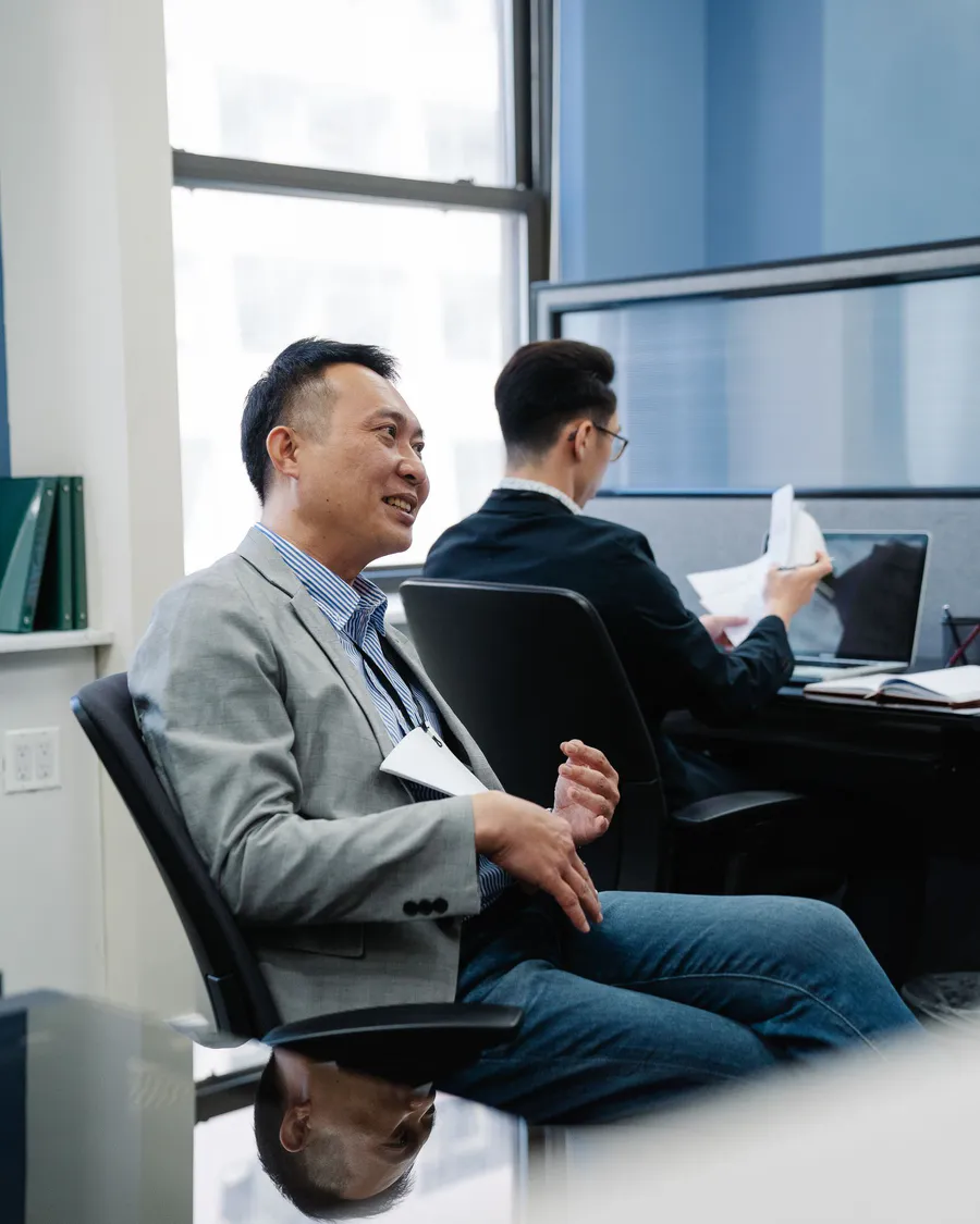 Two business professionals discussing company documents in a modern office